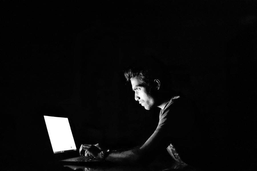 Man hacking computer in dark room